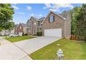 View of home's exterior with long driveway, manicured lawn, and neatly trimmed shrubbery at 4474 Michael Jay St, Snellville, GA 30039