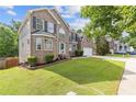 Two story brick home featuring a green lawn, brick facade, and large front-facing windows at 4474 Michael Jay St, Snellville, GA 30039