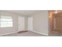 Well-lit living room featuring neutral paint, a window, and a closet at 1079 Stonewall Drive Southeast, Atlanta, GA 30315