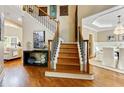Staircase in foyer with hardwood floors leading to dining room and living room at 121 Fairway Overlook, Woodstock, GA 30188