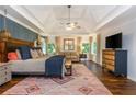 Spacious main bedroom boasting tray ceilings, hardwood floors, and lots of natural light at 210 Hunters Vw, Roswell, GA 30075