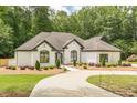 Charming single story home with fresh landscaping, white brick, and dark trim at 6394 Wood Valley Rd, Douglasville, GA 30134