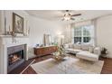 Cozy living room boasts a fireplace, hardwood floors, and comfortable furnishings at 1911 Stancrest Nw Trce, Kennesaw, GA 30152