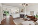 Open concept living room flowing into kitchen, featuring a fireplace and hardwood floors at 1911 Stancrest Nw Trce, Kennesaw, GA 30152