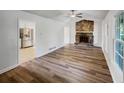 The living room features a stone fireplace and sleek hardwood flooring, adjacent to the kitchen at 2955 Terry Sw Ln, Marietta, GA 30064