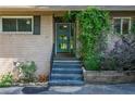 Close up of a light blue front door with brick and greenery at 3300 Wiltshire Dr, Avondale Estates, GA 30002