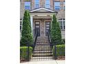 Close-up of the front entrance showcasing brick steps and black railings leading to modern doors at 4107 Township Pkwy # 69, Sandy Springs, GA 30342