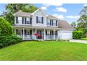 Beautiful two-story home with a lovely front porch, attached garage, and lush green lawn at 10 Callaway Ct, Hiram, GA 30141
