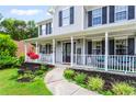 Inviting front porch featuring cozy seating, decorative plants, and a welcoming entryway at 10 Callaway Ct, Hiram, GA 30141