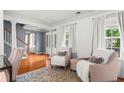 Elegant living room showcasing stylish furniture, hardwood floors, and abundant natural light at 10 Callaway Ct, Hiram, GA 30141