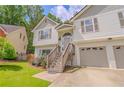 Inviting two-story home with a brick and siding facade, a two-car garage and a beautifully landscaped yard at 3781 Deercreek Dr, Powder Springs, GA 30127