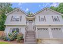 Charming two-story home with a two-car garage, landscaped front yard, and inviting entryway at 3781 Deercreek Dr, Powder Springs, GA 30127