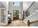 Grand foyer featuring hardwood floors, a staircase with wrought iron spindles, and double front doors at 2845 Aquitania Ln, Cumming, GA 30040