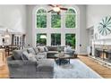 Bright living room featuring a fireplace, hardwood floors, and large windows offering great views at 2845 Aquitania Ln, Cumming, GA 30040