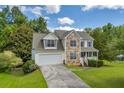 Lovely two-story home with stone accents, a two-car garage, and a well-maintained front yard at 684 Doe Lane Ln, Loganville, GA 30052