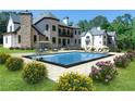 Backyard pool with lounge chairs and umbrella surrounded by beautiful landscaping and luxurious homes at 10745 Shallowford Rd, Roswell, GA 30075