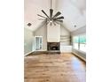 Bright living room features a stone fireplace, hardwood floors and vaulted ceiling at 1273 Jersey Social Circle Rd, Covington, GA 30014