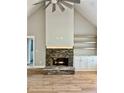 Living room featuring stone fireplace, hardwood floors, built-in shelving and cabinets at 1273 Jersey Social Circle Rd, Covington, GA 30014
