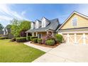 Beautiful home featuring stone accents, a two-car garage, and a well-maintained lawn with mature landscaping at 3012 Keeneland Blvd, Mcdonough, GA 30252