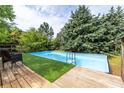 Backyard featuring a refreshing above ground pool with a wooden deck and mature trees for added privacy at 3012 Keeneland Blvd, Mcdonough, GA 30252