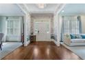 Elegant foyer with hardwood floors, stylish wallpaper, and views into adjoining living spaces at 785 Wilson Nw Rd, Atlanta, GA 30318