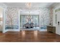 Foyer featuring decorative wallpaper and an entry into a formal dining room with modern chandelier at 785 Wilson Nw Rd, Atlanta, GA 30318