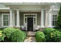 Inviting front porch with elegant columns, stone accents, and comfortable seating at 785 Wilson Nw Rd, Atlanta, GA 30318