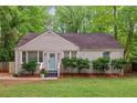 Charming one-story brick home with manicured lawn, landscaped bushes, and a light-blue painted front door at 2599 E Tupelo Se St, Atlanta, GA 30317