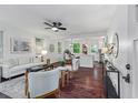 Bright living room with hardwood floors, a ceiling fan, neutral furniture, and an open layout to the kitchen and dining area at 2599 E Tupelo Se St, Atlanta, GA 30317
