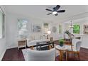 Cozy living room featuring a ceiling fan, neutral furniture, hardwood floors, and abundant natural light from two windows at 2599 E Tupelo Se St, Atlanta, GA 30317