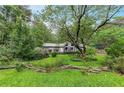 Quaint single-story home with well-kept lawn and landscaping creates a serene and inviting outdoor space at 2736 Whisper Trl, Douglasville, GA 30135