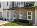 Eye-catching townhome showcasing a brick facade, quaint blue doors, and a charming second-story balcony at 3484 Orchard St, Atlanta, GA 30354