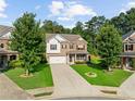 Beautiful two-story home featuring a manicured lawn, complemented by mature trees and a well-maintained exterior at 3962 Roberts Crest Dr, Suwanee, GA 30024