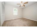 Bedroom featuring a fan, neutral carpet, and closet at 6194 Golden Meadow Court Ct, Riverdale, GA 30296