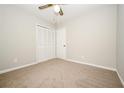 Cozy bedroom with neutral carpet, a ceiling fan, and closet at 6194 Golden Meadow Court Ct, Riverdale, GA 30296