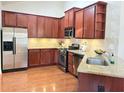 Well-equipped kitchen featuring stainless steel appliances, granite countertops, and wooden cabinets at 120 Chastain Nw Rd # 1803, Kennesaw, GA 30144