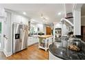 Bright kitchen featuring white cabinets, stainless steel appliances, island, and wood floors at 1438 Salem Dr, Alpharetta, GA 30009