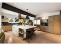 Bright kitchen features a large island with a marble countertop, modern appliances, and hardwood floors at 1656 N Pelham Ne Rd, Atlanta, GA 30324