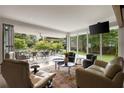 Bright living room with floor to ceiling windows and sliding doors that open to an outdoor living space at 1656 N Pelham Ne Rd, Atlanta, GA 30324