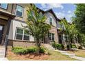 Well-maintained townhome complex showcasing brick and siding exteriors with manicured landscaping at 1004 Bayrose Cir, East Point, GA 30344