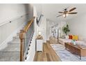 Bright living room showcasing hardwood floors, ceiling fan, staircase, and open concept layout at 1004 Bayrose Cir, East Point, GA 30344