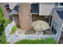 Aerial view of a fenced-in patio area with a patio table with umbrella and manicured landscaping at 563 Trillum Sw Ct # 563, Marietta, GA 30008
