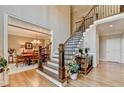Elegant foyer with staircase, hardwood floors, and views into the formal dining room at 10195 Brier Mill Ct, Alpharetta, GA 30022