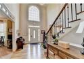 Grand foyer with soaring ceilings, hardwood floors, and staircase with decorative railing at 10195 Brier Mill Ct, Alpharetta, GA 30022
