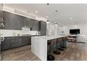 Contemporary kitchen with sleek gray cabinets, white countertops, and bar stool seating at a large island at 1494 Red Fox Ne Dr # D, Atlanta, GA 30306