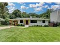 Charming one-story brick home with a well-manicured lawn and a convenient covered carport at 4237 Rickenbacker Ne Way, Atlanta, GA 30342