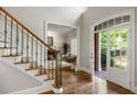 Welcoming foyer with hardwood floors, staircase with iron railing, and views into the living room at 125 Franklin Pl, Atlanta, GA 30342