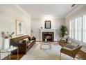 Elegant living room with a marble fireplace, neutral walls, hardwood floors, and a leather sofa at 125 Franklin Pl, Atlanta, GA 30342