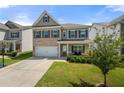 Beautiful two-story home with a well-maintained lawn, covered porch, and attached two-car garage at 1570 Ribbon Mill Sw Ln, Mableton, GA 30126