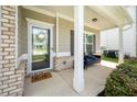 Inviting front porch with seating, a stylish welcome mat, and manicured landscaping at 1570 Ribbon Mill Sw Ln, Mableton, GA 30126